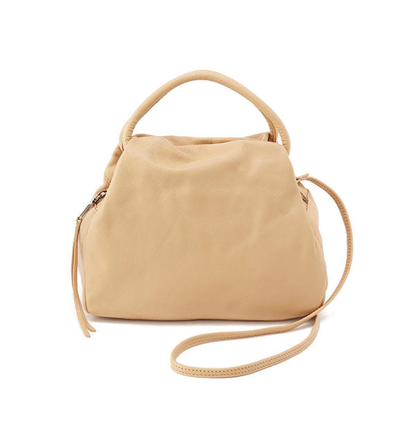 Pale yellow leather bag with top handle and longer strap extended at right