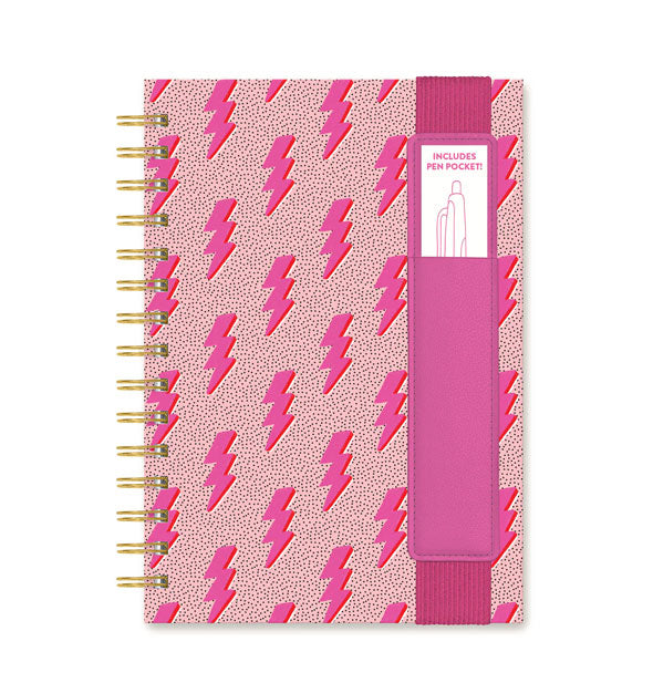 Notebook with gold twin ring spiral binding features pink lightning bolt cover print and a pink pen sleeve attached to an elastic band