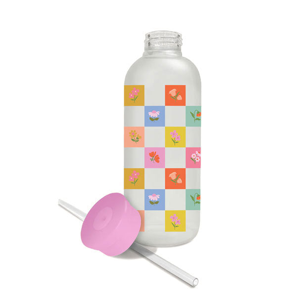 Glass checkerboard flower water bottle with straw and pink cap removed