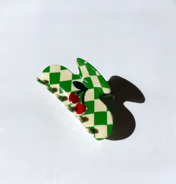 Green and white checkered claw clip with red cherries decal in the center