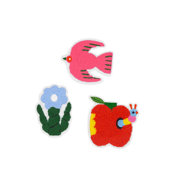 Three textured chenille stickers: a pink bird in flight, a blue flower with thick green stem and leaves, and a red apple with striped worm emerging from a hole in it