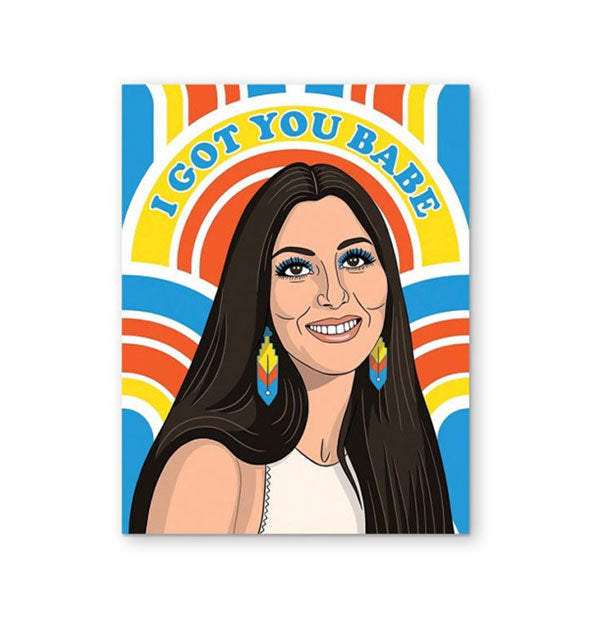 Greeting card featuring portrait of smiling Cher wearing dangle earrings that match a mod primary color background says, "I got you babe" at the top in blue lettering