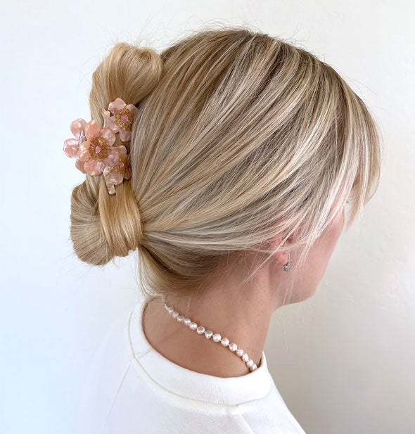 Model wears a cherry blossoms claw clip in a twist updo