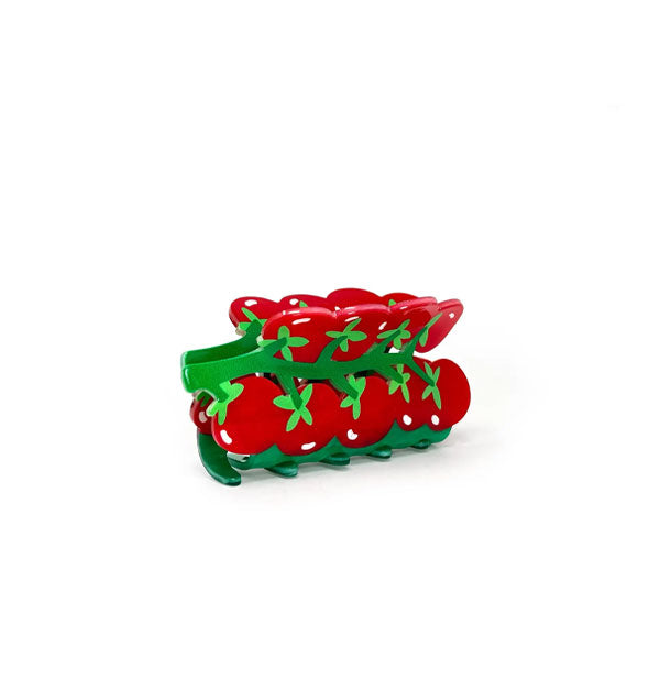 Hair clip that resembles a green vine of red cherry tomatoes