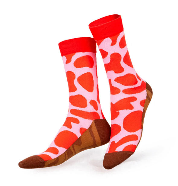 Crew socks with a red and pink abstract print top portion and two-tone brown swirl print bottom and toe