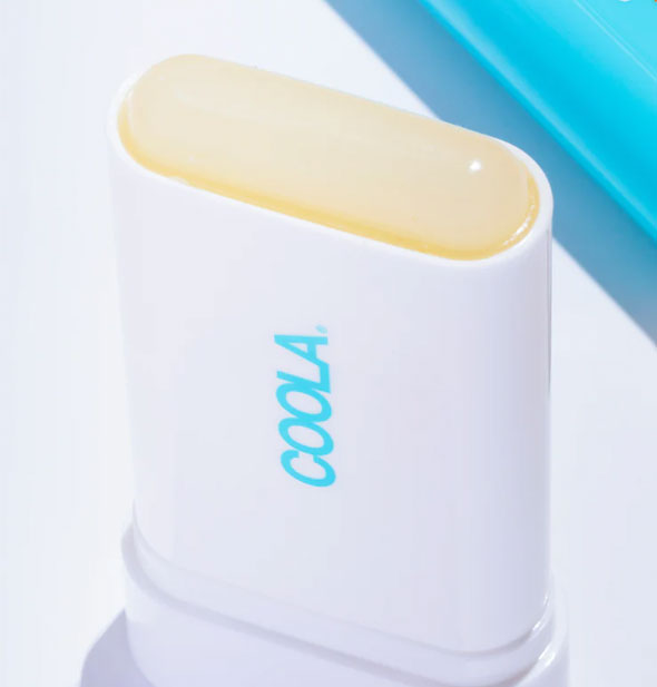 A white tube of Coola Classic Sunscreen Stick with the cap removed