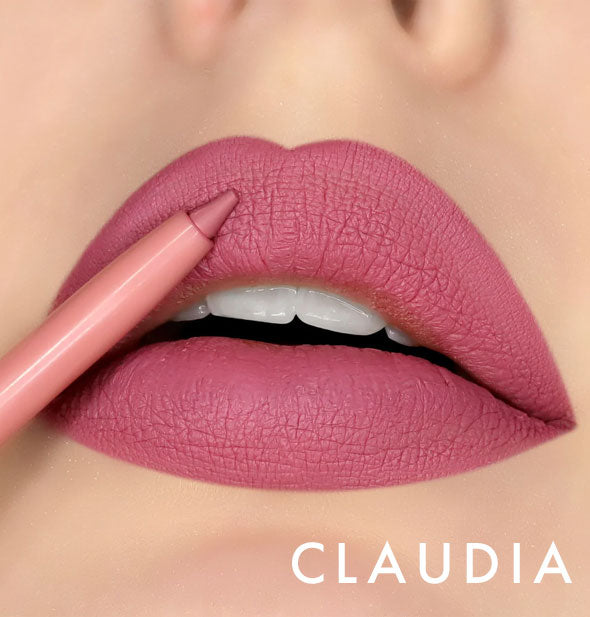 Model's lips wear shade Claudia of Kara Beauty Line Up Lip Liner; pencil tip is held up to upper lip