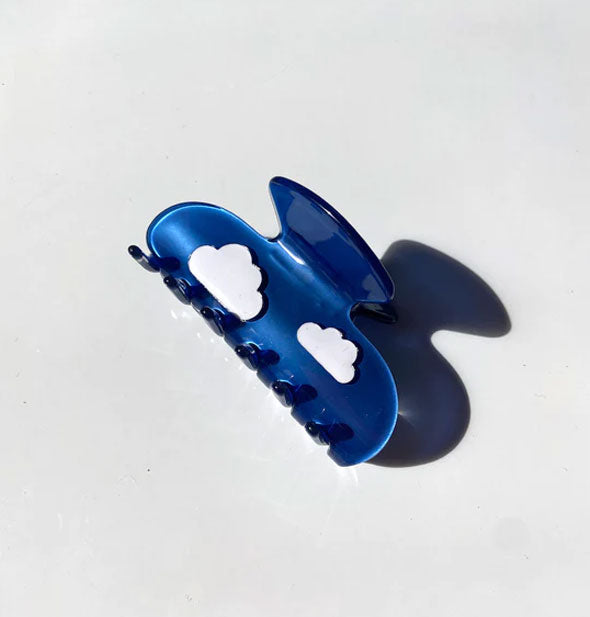 Blue claw clip with two puffy white cloud graphics
