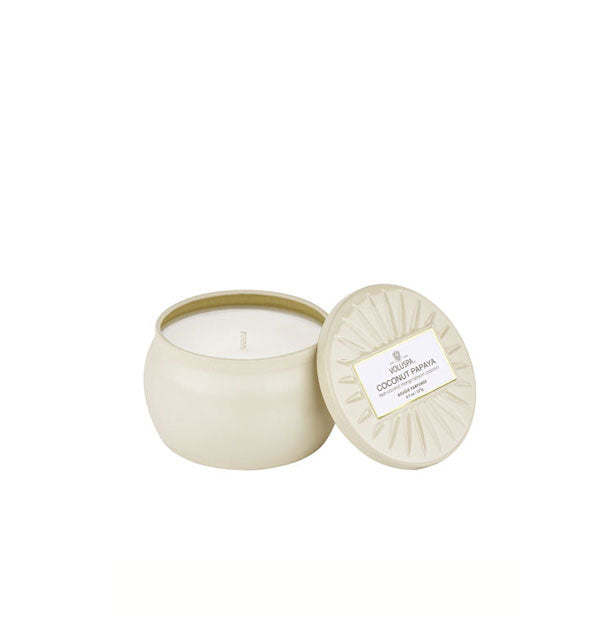 Mini cream-colored tin candle with embossed lid removed