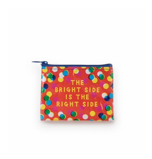 Reddish-orange coin purse with blue zipper says, "The bright side is the right side" in yellow lettering surrounded by colorful dots