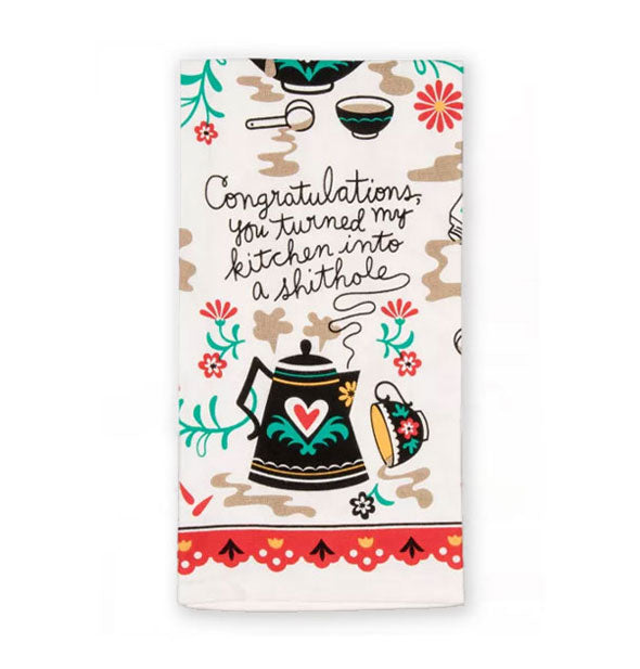 White dish towel with whimsical floral and spilled coffee illustrations says, "Congratulations, you turned my kitchen into a shithole" in black handwritten script rising up from a black coffee pot