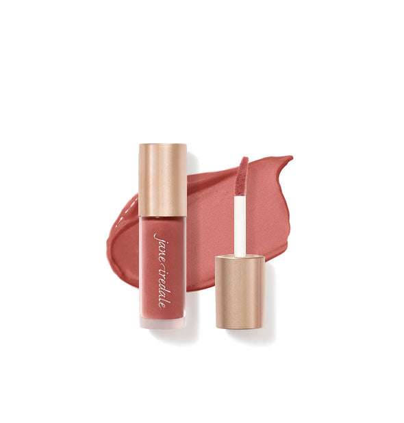 Tube of Jane Iredale Beyond Matte Lip Stain with separate gold doe foot applicator cap rest atop an enlarged sample application of product in shade Content