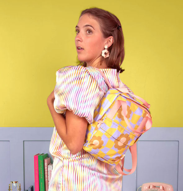 Model wears the Cool Funky Daisy Mini Backpack over left shoulder