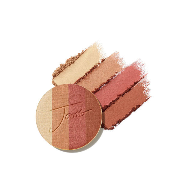 Four-shade bronzer pressed powder compact refill disc stamped with "Jane" is placed in front of crumbled and streaked applications of each shade in Copper Dusk option