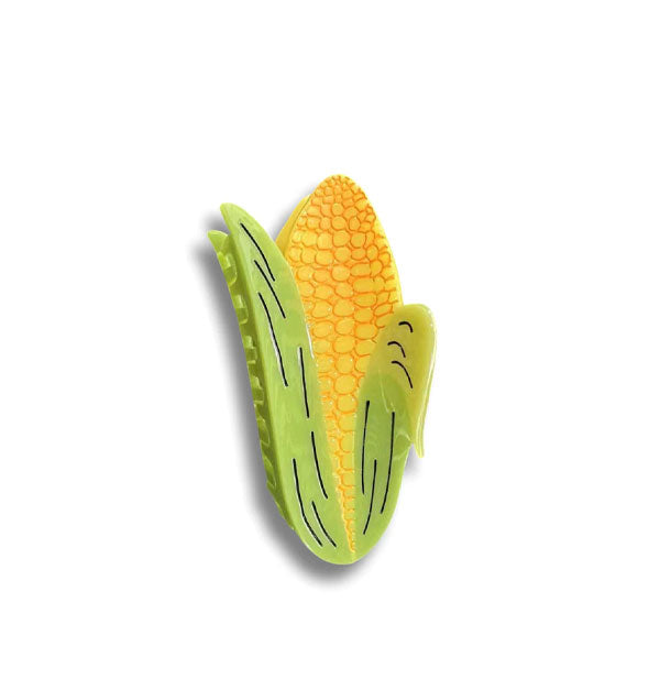 Hair clip designed and colored to resemble an ear of yellow corn with green husk