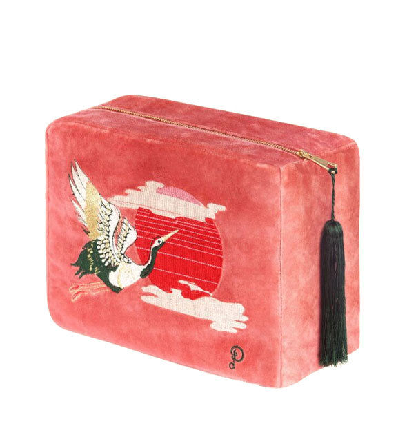Rectangular pink velvet bag with embroidered design of a crane in flight in front of a red sun flanked by clouds; a black tassel zipper pull hangs at the side