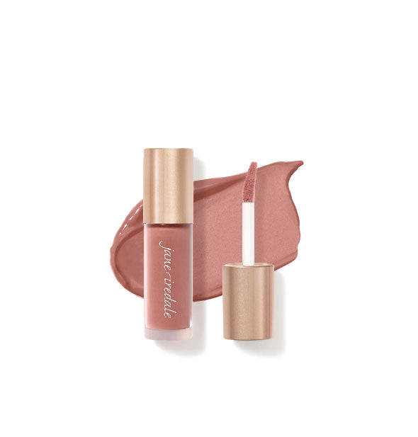 Tube of Jane Iredale Beyond Matte Lip Stain with separate gold doe foot applicator cap rest atop an enlarged sample application of product in shade Craving