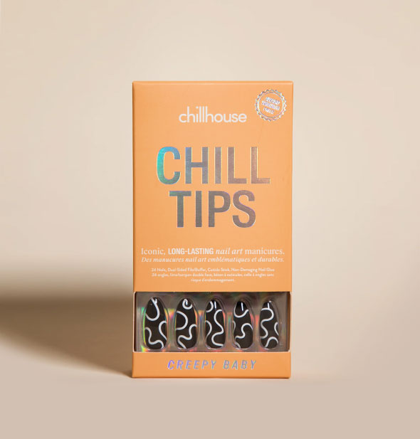 Light orange box of Chillhouse Chill Tips press on nails in Creepy Baby design partially visible through window in packaging: black with wavy abstract white lines