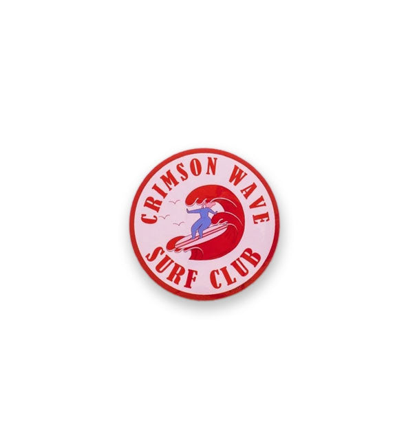 Round sticker with surfer graphic says, "Crimson Wave Surf Club"