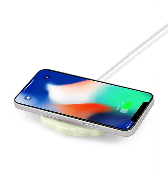 A charging smartphone rests on a Crystal Quartz Wireless Charger