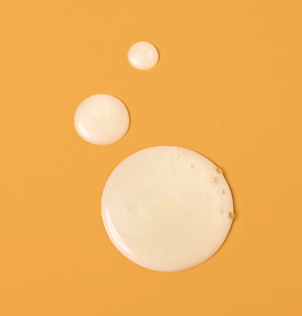 Droplets of Verb Curl Shampoo on an orange surface