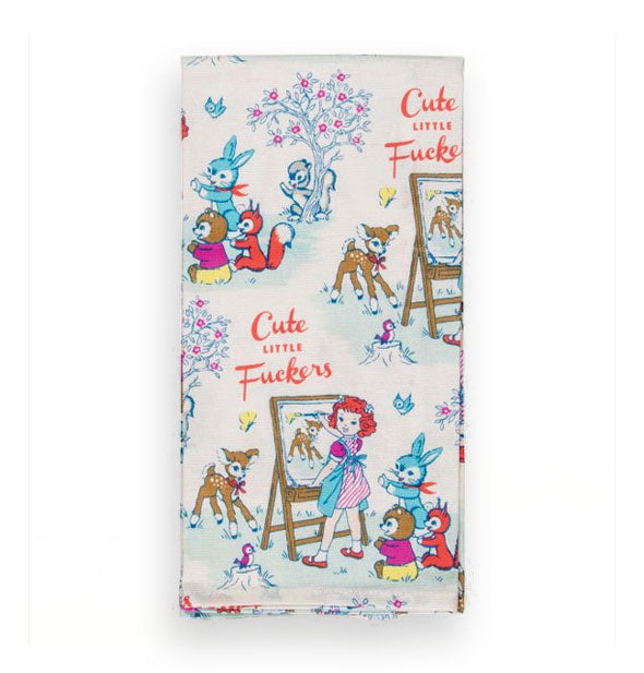 Dish towel with repeated illustration of a little girl painting a fawn with other woodland creatures surrounding her says, "Cute Little Fuckers" in red lettering