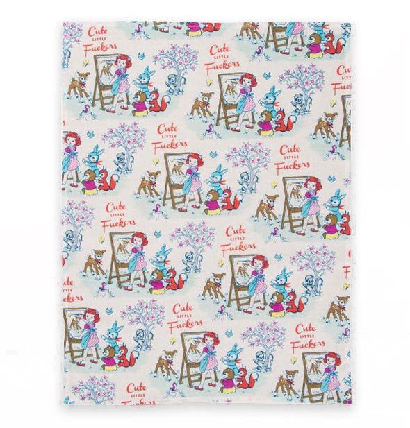 Dish towel with repeated illustration of a little girl painting a fawn with other woodland creatures surrounding her says, "Cute Little Fuckers" in red lettering