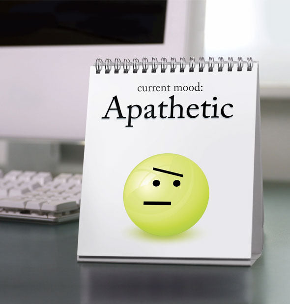 A Daily Mood Desktop Flip Book is turned to a page reading, "Apathetic" with green smiley face illustration