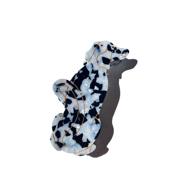 Black and white hair claw designed and painted to resemble a Dalmatian dog with gold accent lines