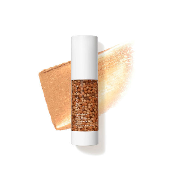 Bottle of Jane Iredale HydroPure Tinted Serum with color capsules visible through clear packaging and a sample application behind in the shade Dark 6