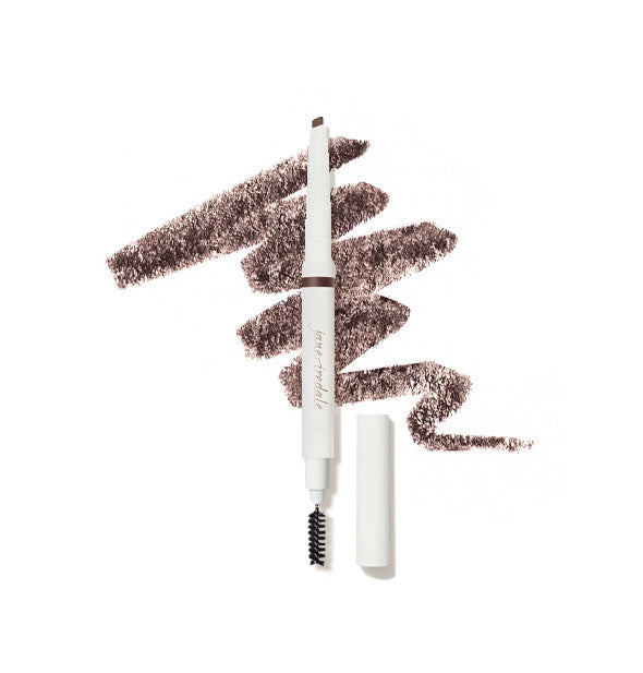 White Jane Iredale brow pencil with cap removed to show angled tip on top and spoolie brush on bottom is placed in front of a drawn squiggle of product in shade Dark Brown