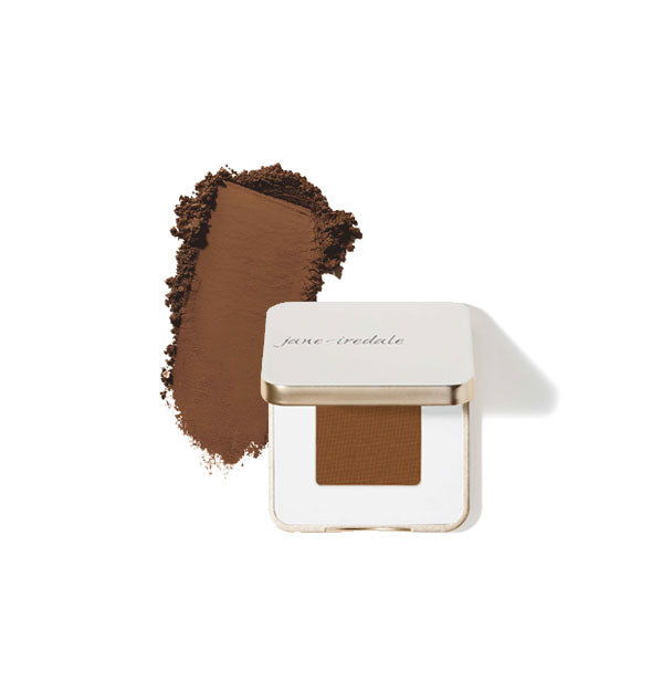Opened square white and gold Jane Iredale eye shadow compact with sample product application at left in the shade Dark Suede