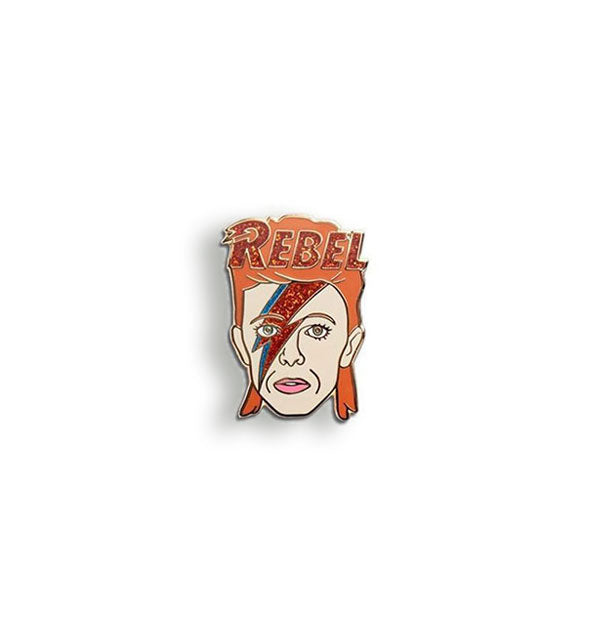 Enamel pin designed in the likeness of David Bowie as Ziggy Stardust with glittery lightning bolt over face and the word, "Rebel" across his orange hair