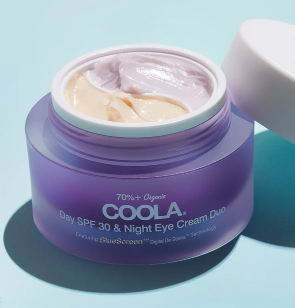 Opened pot of Coola Day SPF 30 & Night Eye Cream Duo shows divided products inside