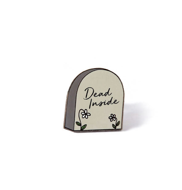 Enamel pin designed to resemble a graveyard headstone says, "Dead Inside" with two daisies below