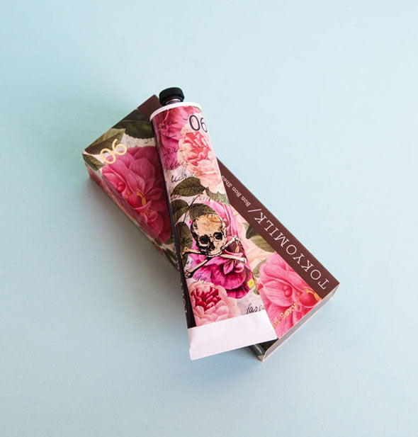 Tube and box of TokyoMilk Bon Bon Shea Butter Lotion with pink floral motif and skull and crossbones graphic