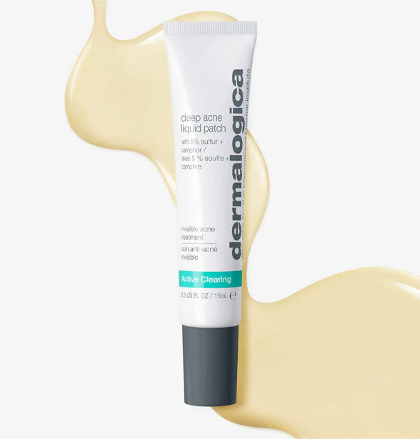 Tube of Dermalogica Deep Acne Liquid Patch rests overtop dispensed sample product that is lightly golden in color