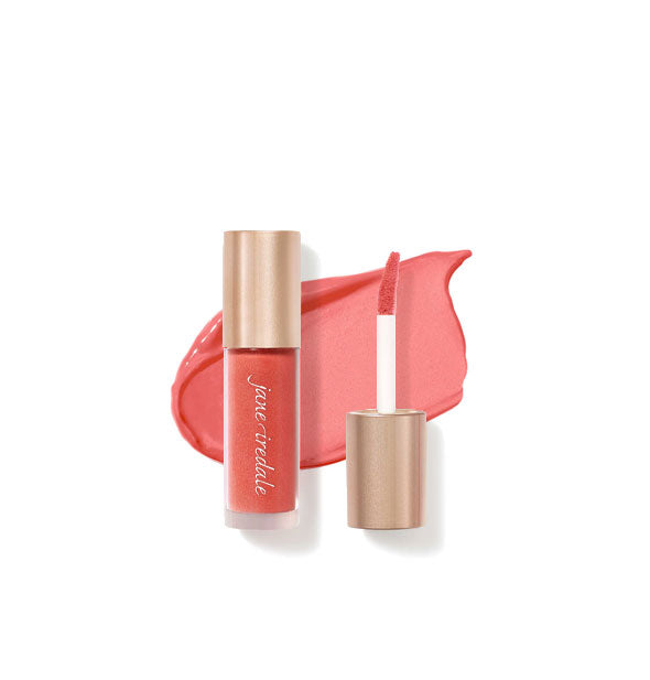 Tube of Jane Iredale Beyond Matte Lip Stain with separate gold doe foot applicator cap rest atop an enlarged sample application of product in shade Devotion