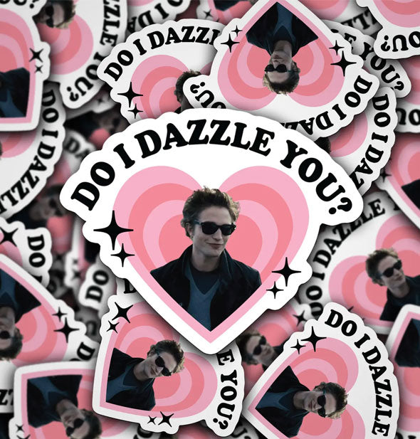 Smattering of stickers featuring a portrait of Robert Pattinson as Edward Cullen in the Twilight series framed by radiating pink hearts and black stars that say, "Do I dazzle you?" at the top