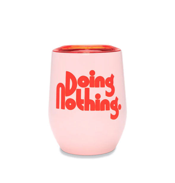 Stemless pink wine tumbler with clear red lid says, "Doing Nothing." in red lettering