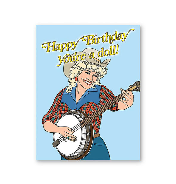 Blue greeting card with illustration of smiling Dolly Parton playing a banjo says, "Happy Birthday You're a Doll!" at the top in yellow lettering
