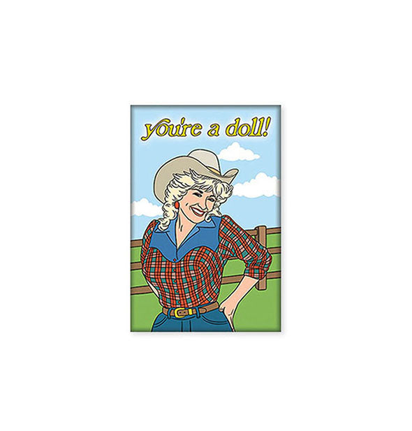 Rectangular magnet featuring illustration of Dolly Parton in Western attire against a blue sky, green pasture, and wooden fence backdrop says, "You're a doll!" at the top in yellow lettering