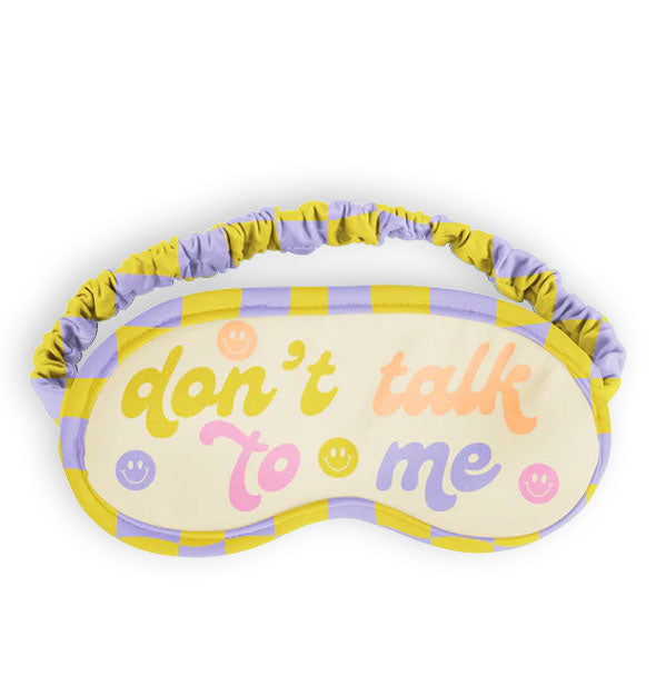 Sleep mask with purple and yellow checker border and ruched elastic band says, "Don't talk to me" in multicolor retro-style script accented with color coordinating smiley faces
