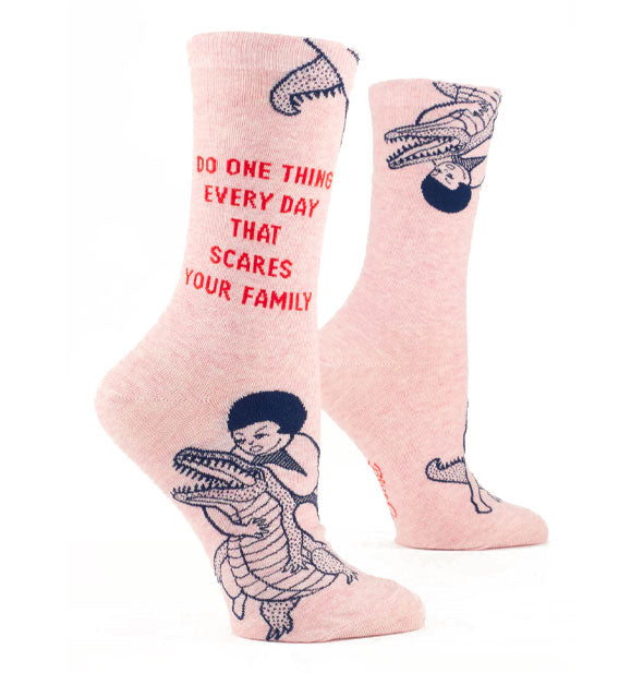 Light pink socks feature illustration of a girl wrestling an alligator in black and the words, "Do one thing every day that scares your family" in red