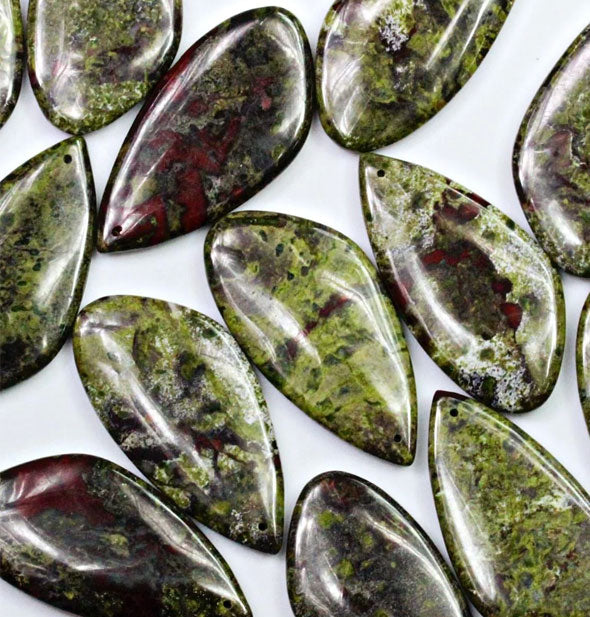 Assortment of dragon blood jasper stones with mottled green and red colorations