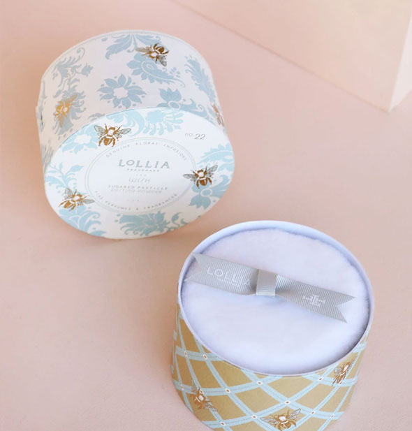 Opened Lollia Dusting Powder container shows puff inside with ribbon handle