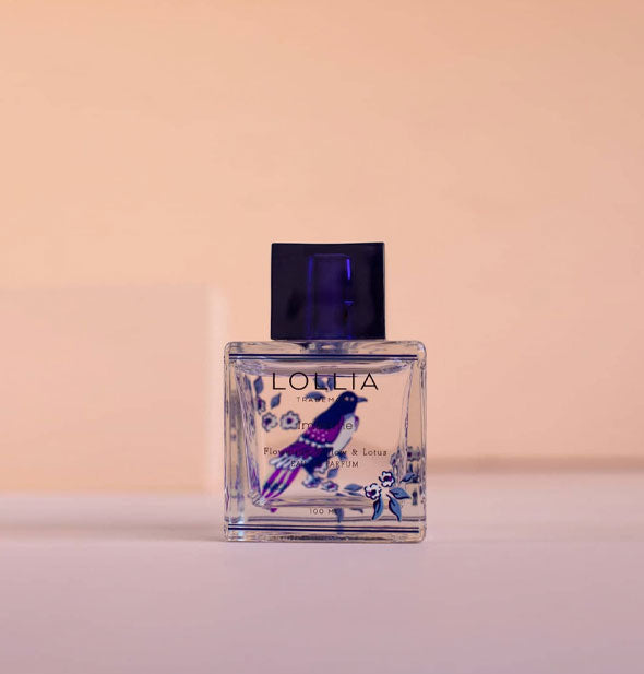 Square glass perfume bottle with indigo flowers and cap features a central songbird design