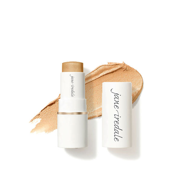 White tube of Jane Iredale Glow Time Highlighter Stick with cap removed overtop an enlarged sample product application in shade Eclipse