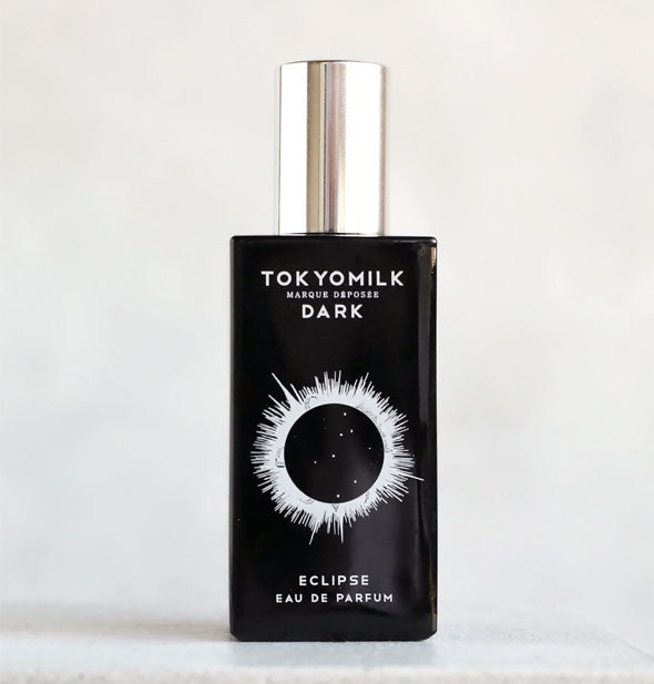 Rectangular black bottle of TokyoMilk Eclipse Eau de Parfum with white lettering and solar eclipse graphic