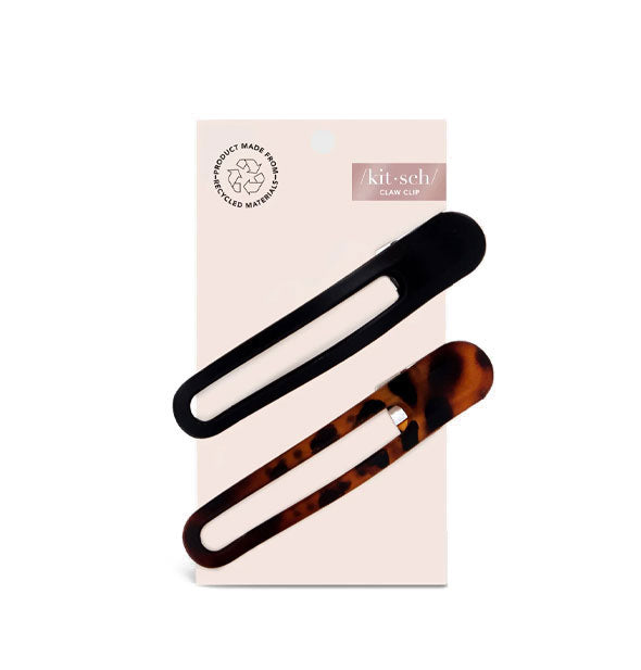 Two slotted hair clips, one black and one brown tortoise, on a light pink Kitsch product card